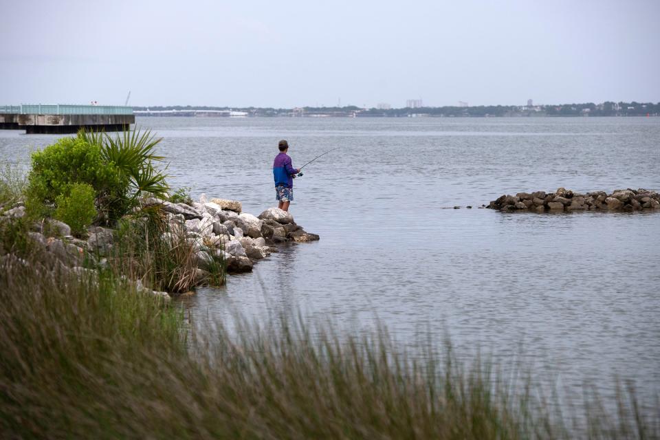 Ben Vincent tries his luck fishing for redfish at Bruce Beach in May. ECUA and the city of Pensacola are struggling to pinpoint what is polluting the water.