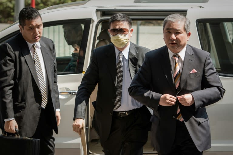 Francis Kwan (C), former non-executive director of New Environmental Energy Holdings Ltd., arrives at the court for a hearing on a corruption case in Hong Kong, in 2013