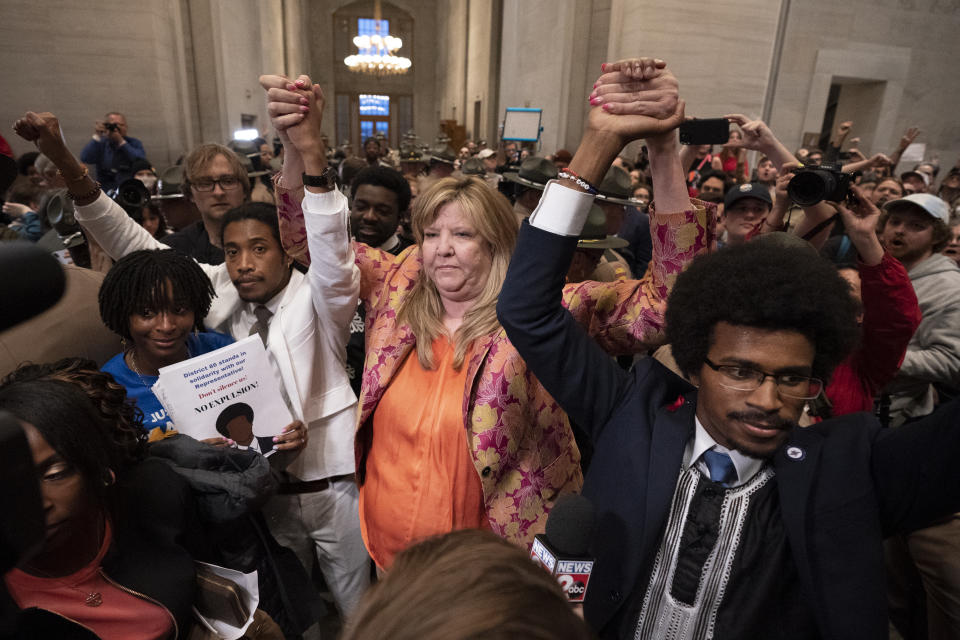 Former Rep. Justin Jones, D-Nashville, Rep. Gloria Johnson, D-Knoxville, and former Rep. Justin Pearson, D-Memphis, raises their hands outside the House chamber after Jones and Pearson were expelled from the legislature Thursday, April 6, 2023, in Nashville, Tenn. (AP Photo/George Walker IV)