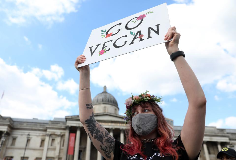 An activist from the climate protest group Extinction Rebellion holds a placard in Trafalgar Square in London on September 1, 2020, at the start of their new season of "mass rebellions". - Climate protest group Extinction Rebellion will target Britain's parliament as part of "mass rebellions" starting from September 1. Other actions will take place around the country. (Photo by ISABEL INFANTES / AFP) (Photo by ISABEL INFANTES/AFP via Getty Images)