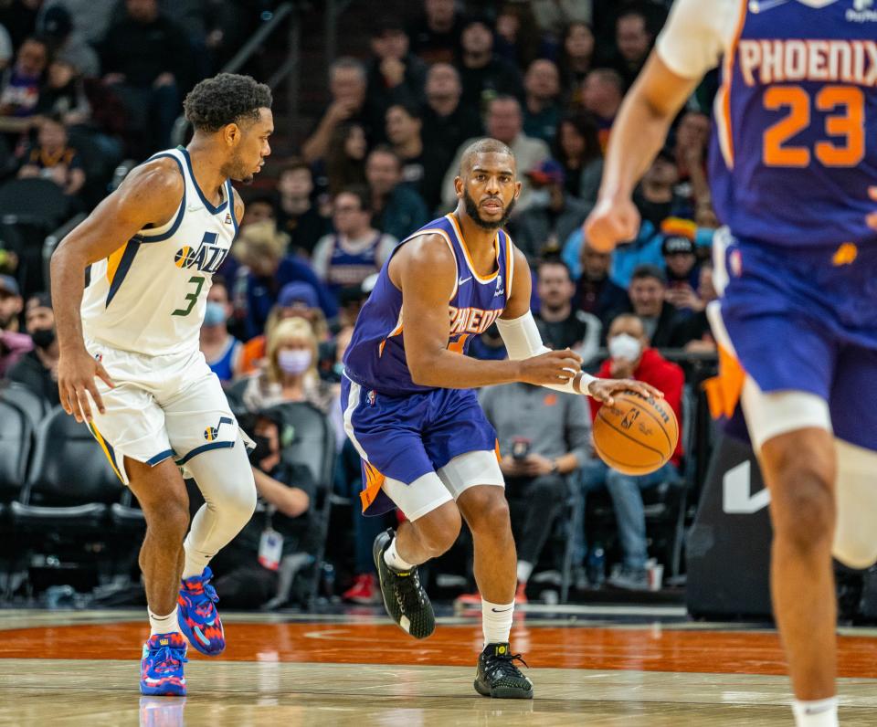 Phoenix Sun guard Chris Paul (3) drives down the court while being defended by Utah Jazz guard Trent Forrest (3) at the Footprint Center on Monday, Jan. 24, 2022.