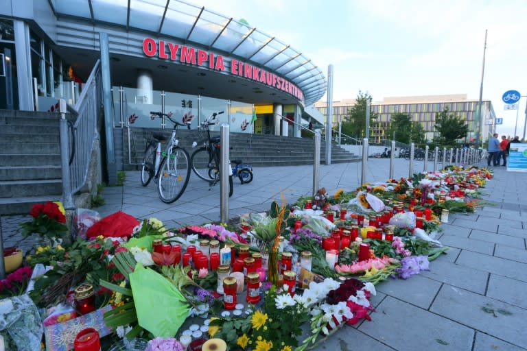 A memorial of candles and flowers in front of the Olympia Einkaufszentrum shopping centre in Munich where a teenager went on a shooting spree in what appears to have been a premeditated attack, before turning the gun on himself