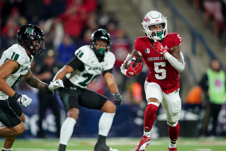 Nov 5, 2022; Fresno, California, USA; Fresno State Bulldogs wide receiver Jalen Moreno-Cropper (5) scores on a 59 yard touchdown reception against Hawaii Rainbow Warriors safety Kaulana Makaula (19) in the third quarter at Valley Children’s Stadium. Mandatory Credit: Cary Edmondson-USA TODAY Sports