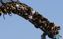 Visitors enjoy a ride a roller coaster at Cinecitta' World amusement park in the outskirts of Rome in the day of its reopening, Thursday, June 17, 2021. Amusement parks have been closed since Oct. 25 2020, when Italy's second national lockdown started. (AP Photo/Alessandra Tarantino)