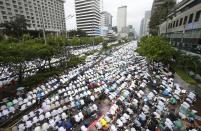 In this Friday, Dec. 2, 2016 file photo, Muslims attend Friday prayer during a rally against Jakarta's minority Christian Governor Basuki "Ahok" Tjahaja Purnama who is being prosecuted for blasphemy, at the main business district in Jakarta, Indonesia. Ahok, the first ethnic Chinese governor of Jakarta and the first Christian in more than half a century, had seemed unassailably popular until the accusation of blasphemy, a criminal offense in Indonesia, surfaced in September. Protests against him in November and December, organized by hard-line Islamic groups, drew hundreds of thousands to Jakarta's streets and shook the centrist-minded government of President Joko "Jokowi" Widodo. (AP Photo/Achmad Ibrahim, File)