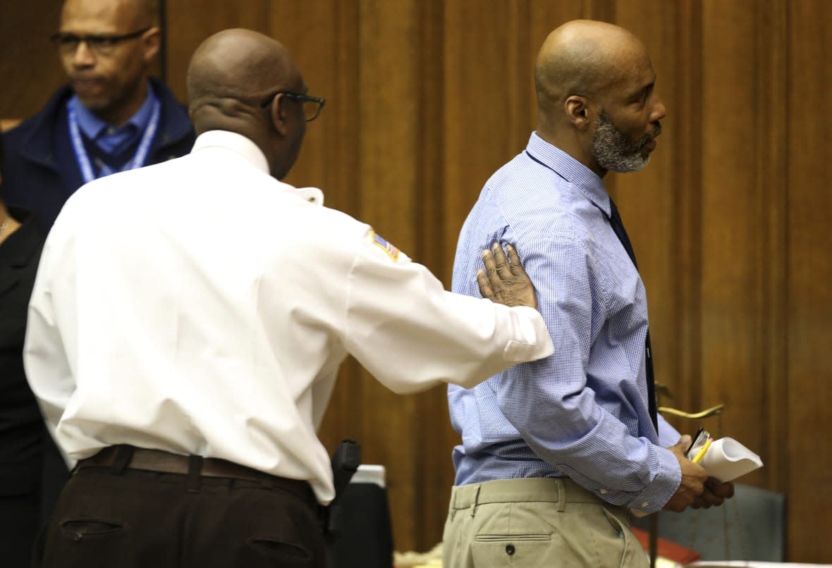 Lamar Johnson, right, gets a congratulatory pat on the shoulder from St. Louis Sherriif Vernon Betts on Tuesday, Feb. 14, 2023, after St. Louis Circuit Judge David Mason vacated Johnson’s murder conviction during a hearing in St. Louis, Mo. (Christian Gooden/St. Louis Post-Dispatch via AP, Pool)