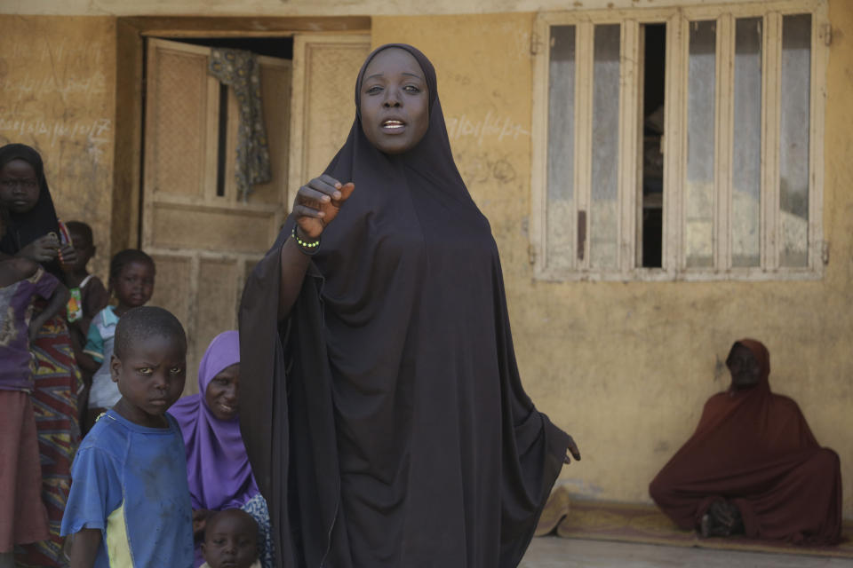 In this photo taken on Thursday, Feb. 21, 2019, Mariam Musa, 32-year-old, a woman displaced by Islamist extremist gesture at Malkohi camp in Yola, Nigeria. Mariam Musa gestured with her hand toward the mouth, twisting her face as she told of her main problem: what to eat and what to drink, in the makeshift camp for internally displaced people that she shares with hundreds. (AP Photo/ Sunday Alamba)