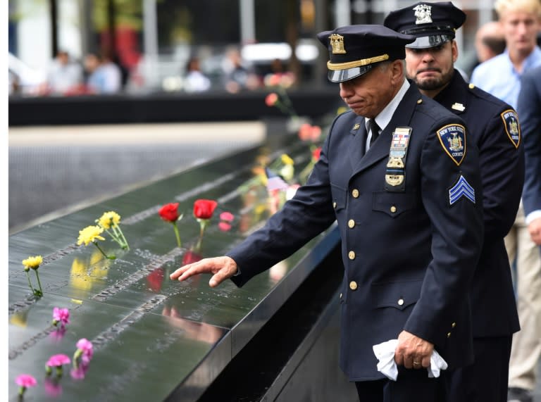 A New York State Court Sergeant looks down into the South Pool during 9/11 observances at Ground Zero