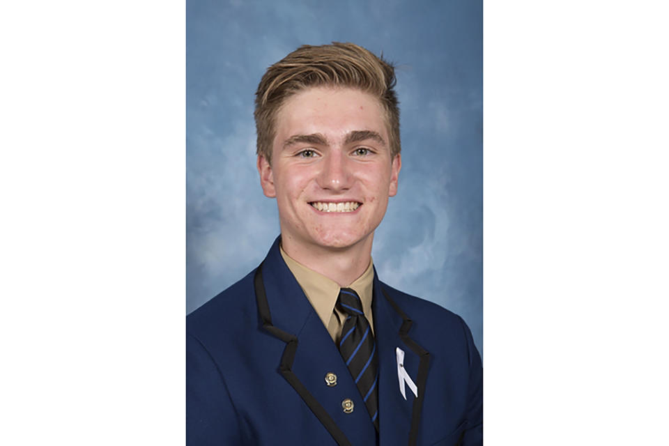 In this undated photo provided by his family/Knox Grammar School, Berend Hollander poses for a class photo in Sydney, Australia. Hollander died in a hospital from injuries after a volcano erupted near Whakatane, New Zealand, Monday, Dec. 9, 2019. (Family/Knox Grammar School via AP)