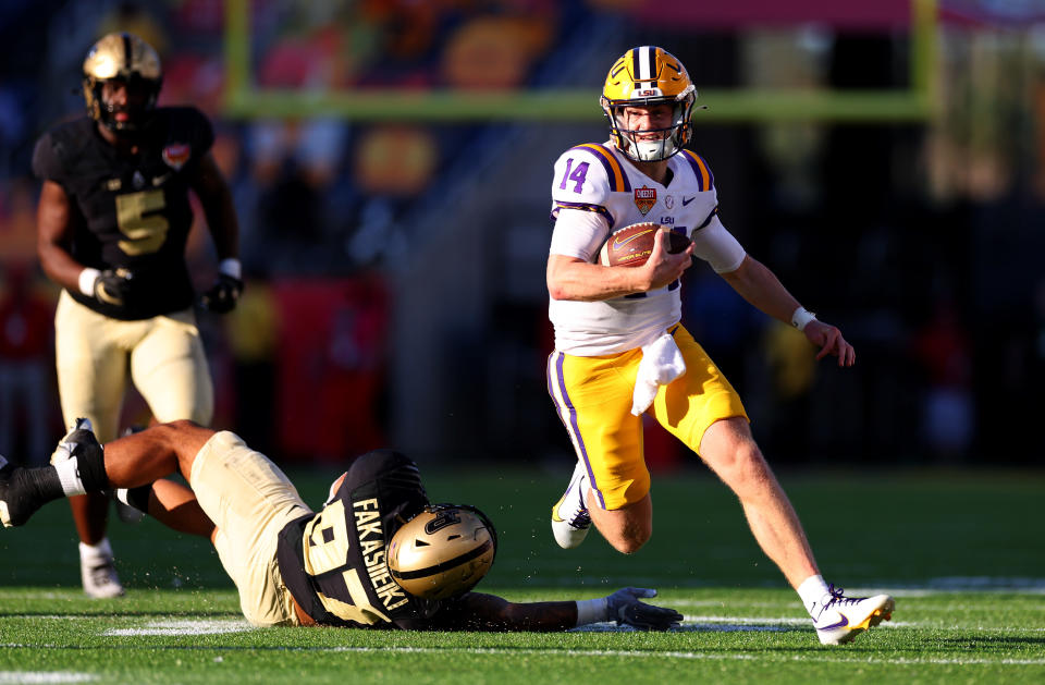 ORLANDO, FLORIDA - JANUARY 02: Walker Howard #14 of the LSU Tigers scrambles during the Cheez-It Citrus Bowl against the Purdue Boilermakers at Camping World Stadium on January 02, 2023 in Orlando, Florida. (Photo by Mike Ehrmann/Getty Images)