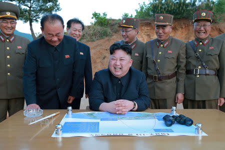 FILE PHOTO : North Korean leader Kim Jong Un reacts during the long-range strategic ballistic rocket Hwasong-12 (Mars-12) test launch with Ri Pyong Chol (2nd L), Kim Jong Sik (C) and Jang Chang Ha (2nd R). in this undated photo released by North Korea's Korean Central News Agency (KCNA) on May 15, 2017. KCNA via REUTERS/File Photo