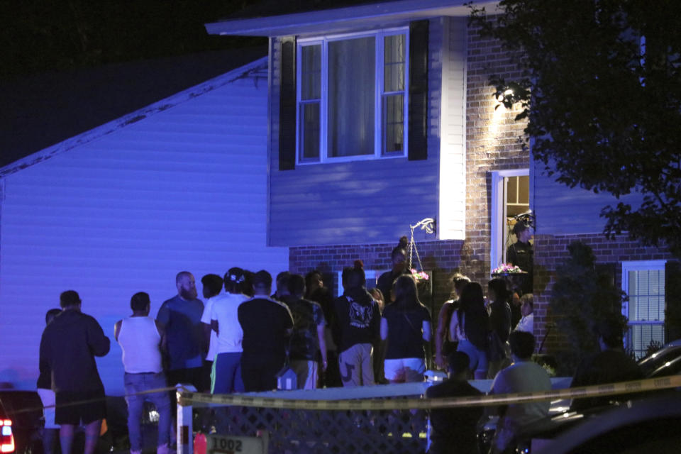 People gather on a residential street in Annapolis, Md., where police say multiple people were shot at a home on Sunday, June 11, 2023. (AP Photo/Brian Witte)