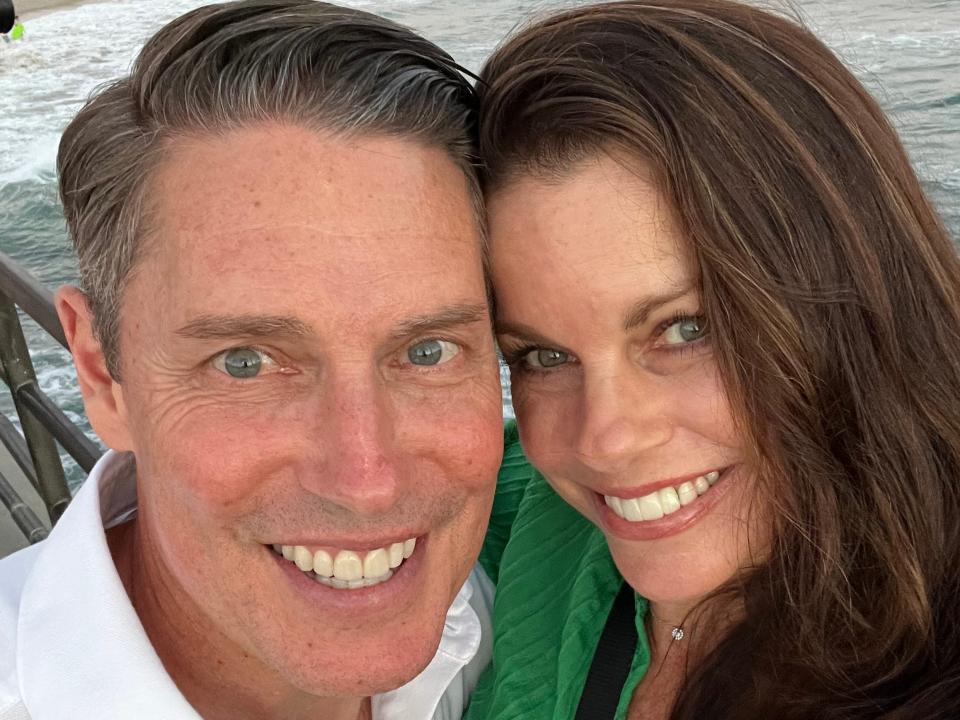 A selfie of a couple taken near a beach.