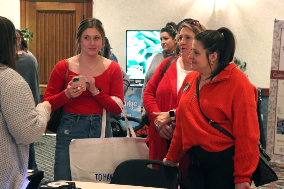 Taylor, Melissa and Paige Miller visit with vendors at the 2023 Amarillo Bridal Show held at the Amarillo Civic Center Sunday afternoon.