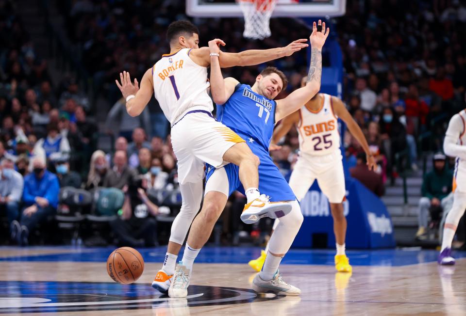 Jan 20, 2022; Dallas, Texas, USA;  Phoenix Suns guard Devin Booker (1) and Dallas Mavericks guard Luka Doncic (77) collide during the first half at American Airlines Center. Mandatory Credit: Kevin Jairaj-USA TODAY Sports