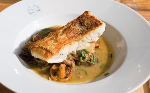 Roast hake, wild mushrooms, fino, parsley, garlic and jamón - Credit: Andy Sewell