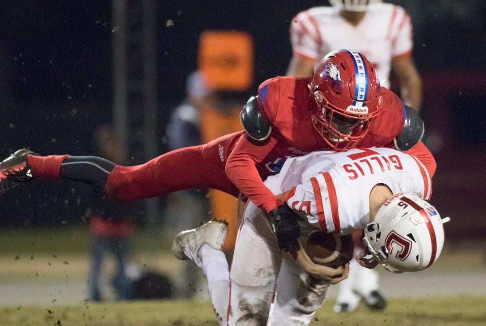 Devon Witherspoon (21) sacks quarterback John Gillis (5) during the Crestview vs Pine Forest playoff football game at Pine Forest High School on Friday, November 16, 2018.