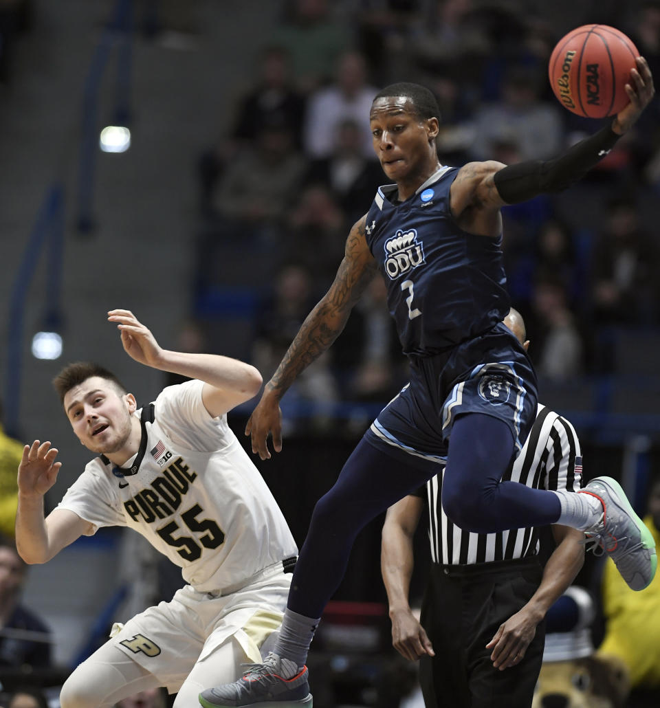 Old Dominion's Justice Kithcart, right, keeps the ball in play as Purdue's Sasha Stefanovic, left, defends during the first half of a first round men's college basketball game in the NCAA tournament, Thursday, March 21, 2019, in Hartford, Conn. (AP Photo/Jessica Hill)