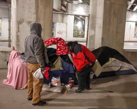 Richard S. Vargas, The Salvation Army Director of Community Social Services, checks on homeless Blanca Rodriguez for cold wellness checkup in Chicago, Illinois, U.S., January 31, 2019. REUTERS/Kamil Krzaczynski