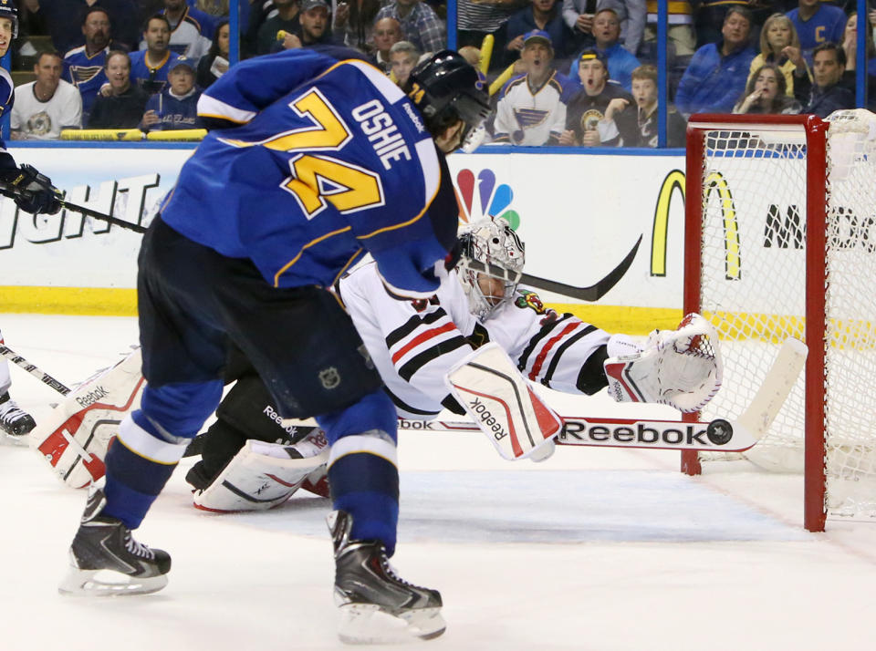 Chicago Blackhawks goaltender Corey Crawford dives back across the crease to try and stop a wide-open shot by St. Louis Blues right wing T.J. Oshie in third period action during Game 5 of a Western Conference quarterfinal playoff game Friday, April 25, 2014, at the Scottrade Center in St. Louis. (AP Photo/The St. Louis Post-Dispatch, Chris Lee)