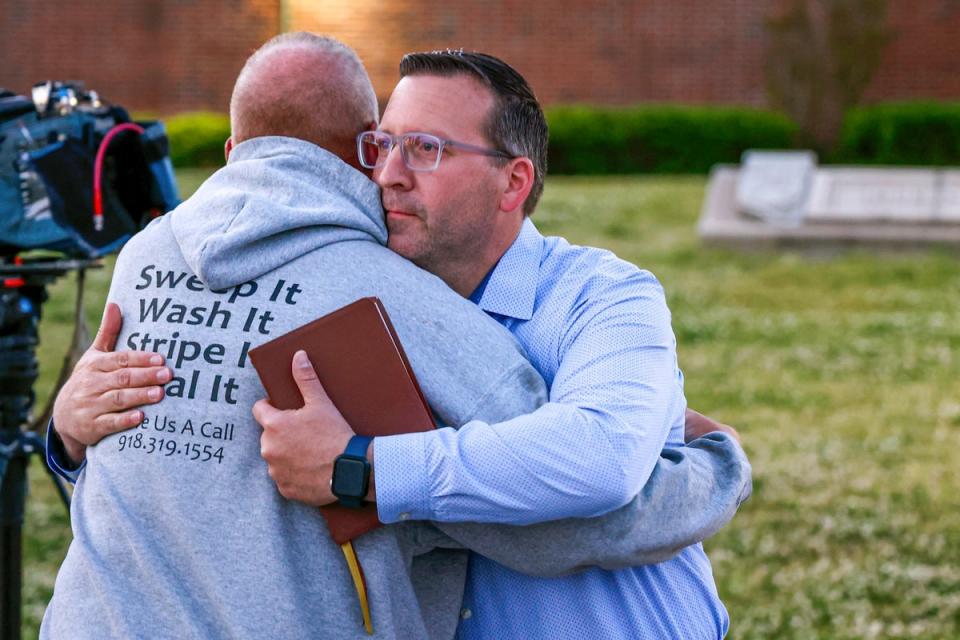 Pastor Ryan Wells hugs Nathan Brewer, the father of Brittany Brewer who was found dead, after a vigil in Henryetta (OKLAHOMAN)