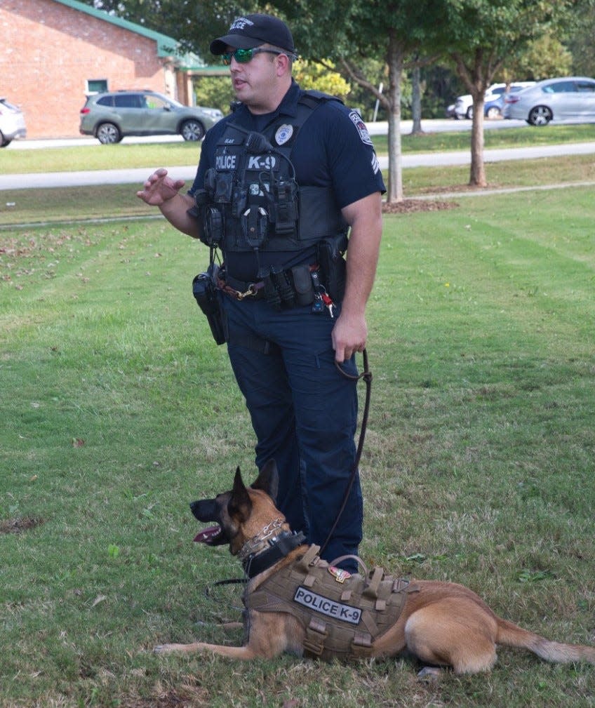 Athens-Clarke police Sgt. Scott Blair with his K-9 Vilma, who is wearing a protective vest. The department's new K-9s will be outfitted with newer models of armor.