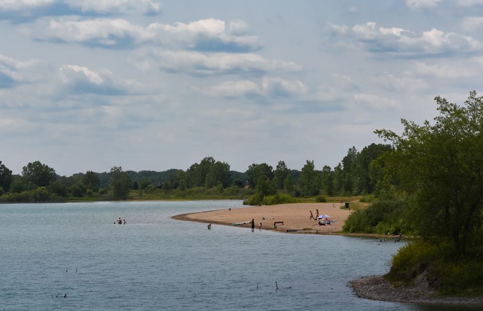 People swim and sunbathe at Clinton Lakes County Park in Clinton County (across the road from Motz County Park) Wednesday, June 14, 2023, near St. Johns.