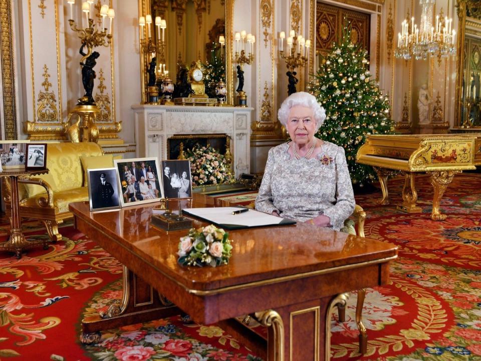 Queen Elizabeth giving her annual Christmas day message in 2018 with pictures of her family (AP)