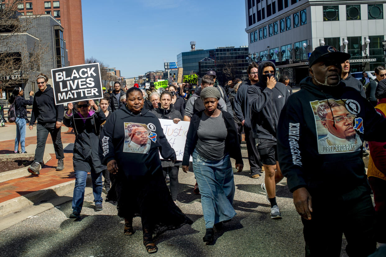 Dorcas Lyoya, mother of Patrick Lyoya, center left, marches alongside supporters wearing all black on Thursday, April 21, 2022 at a rally at the Capitol in Lansing, Mich. to demand justice in the police shooting that took the life of Congolese immigrant Patrick Lyoya. (Jake May/The Flint Journal via AP)