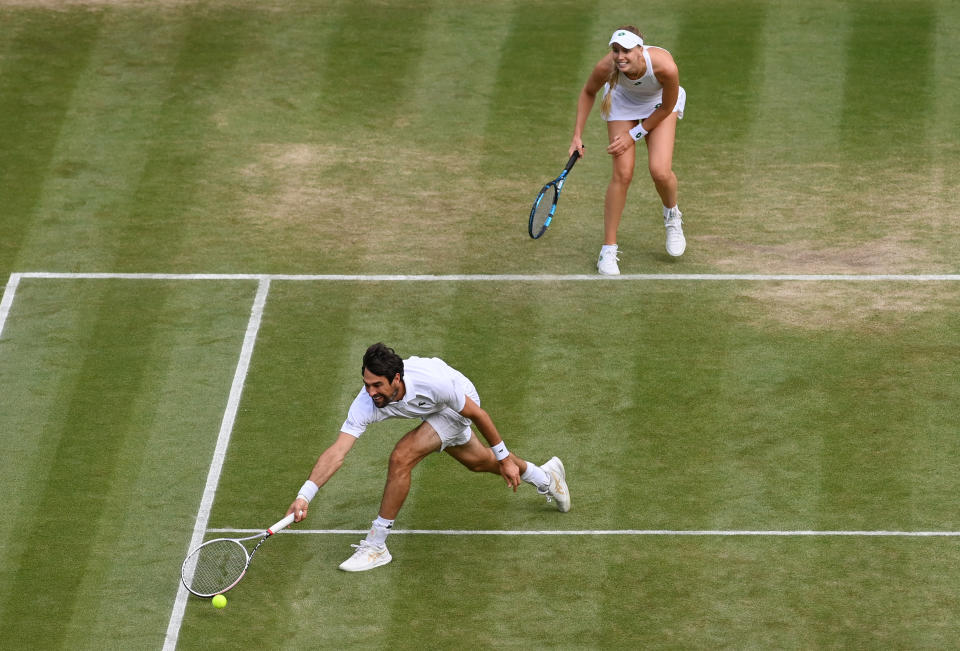Jeremy Chardy of France, playing partner of Naomi Broady of Great Britain stretches to play a forehand in their Mixed Doubles Quarter-Final match against Joe Salisbury and Harriet Dart of Great Britain on Day Ten of The Championships - Wimbledon 2021 at All England Lawn Tennis and Croquet Club on July 08, 2021 in London, England. (Photo by Mike Hewitt/Getty Images)