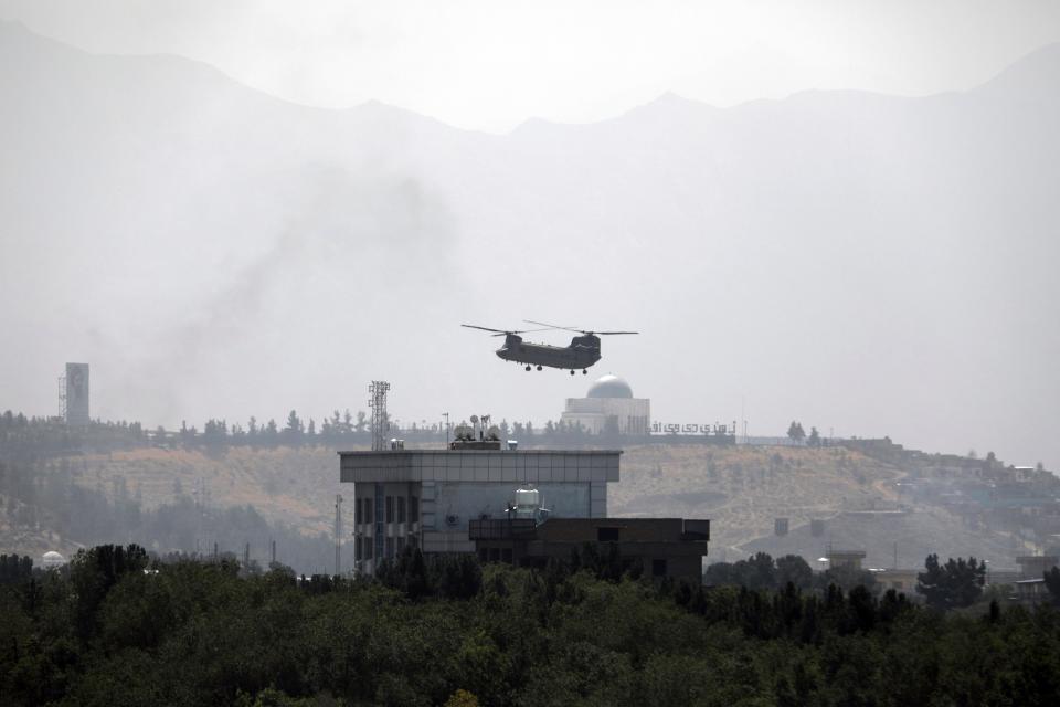 A U.S. Chinook helicopter flies over the U.S. Embassy in Kabul, Afghanistan, Sunday, Aug. 15, 2021.