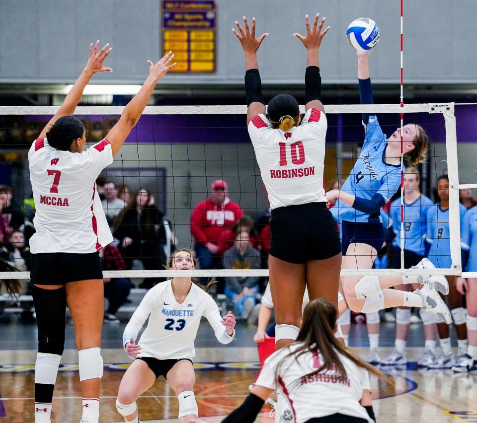 Wisconsin middle blocker Devyn Robinson (10) attempts to block the spike from Marquette outside hitter Jenna Reitsma (4) during the third set of their scrimmage match on Friday March 31, 2023 at Oconomowoc High School in Oconomowoc, Wis.