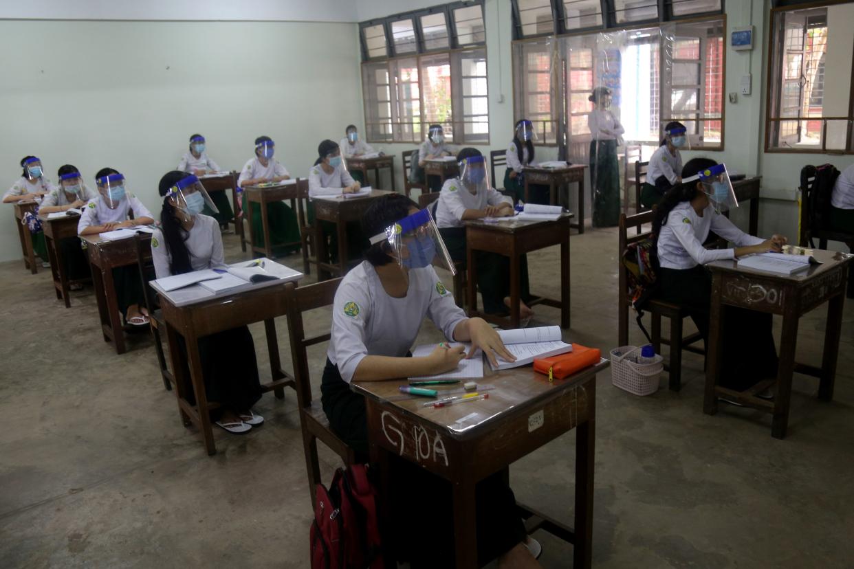 Students wearing masks and face shields attend classes with social distancing measure during the first day of reopening of public high schools following closure due to the coronavirus in Yangon, Myanmar on July 21, 2020.