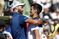 Mar 23, 2018; Key Biscayne, FL, USA; Novak Djokovic of Serbia (R) hugs Benoit Paire of France (L) after their match on day four of the Miami Open at Tennis Center at Crandon Park. Paire won 6-3, 6-4. Mandatory Credit: Geoff Burke-USA TODAY Sports