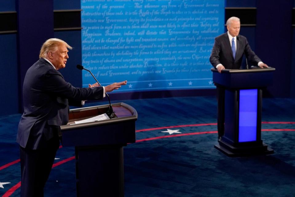 PHOTO: President Donald Trump answers a question as Democratic presidential candidate former Vice President Joe Biden listens during the second and final presidential debate at Belmont University on October 22, 2020 in Nashville, Tennessee. (Morry Gash/Getty Images)