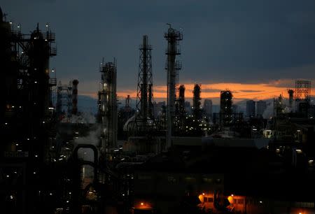 Steam is emitted from factories at sunset in Keihin industrial zone in Kawasaki, Japan February 13, 2017. REUTERS/Issei Kato