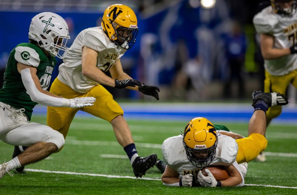 Grand Rapids West Catholic's Gabe Schwieters (84) tackles Negaunee's Phil Nelson (10) during the first half of the Division 6 Michigan high school football final at Ford Field in Detroit on Friday, Nov. 25, 2022.