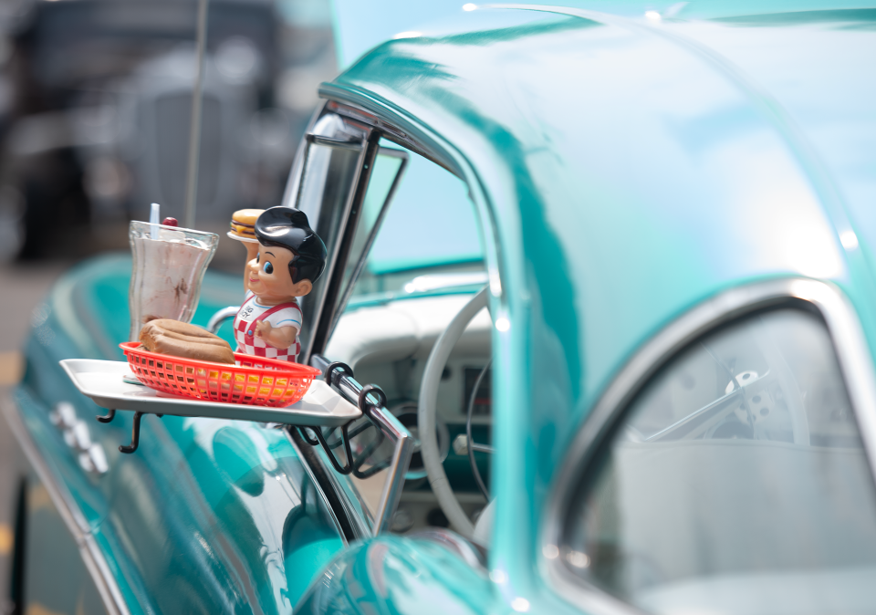 A 1957 Buick Special with a classic Bob's Big Boy tray of a burger and milkshake at Octane Nights car show Wednesday in Ravenna.