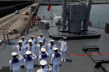 Navy personnel salute as officers board Kee Lung (DDG-1801) destroyer during a drill near Yilan naval base, Taiwan April 13, 2018. REUTERS/Tyrone Siu