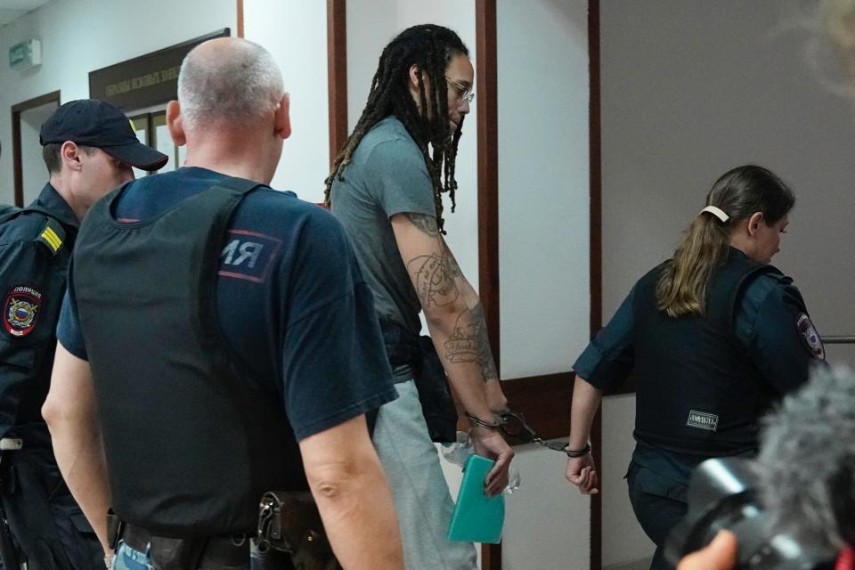 Brittney Griner being led by Russian officers at pre-trial hearing.