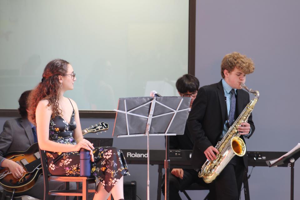 Xander Salsitz, right, plays the saxophone during a media event for the Village of ORC at the Oxford Recovery Center on Tuesday, June 7, 2022.