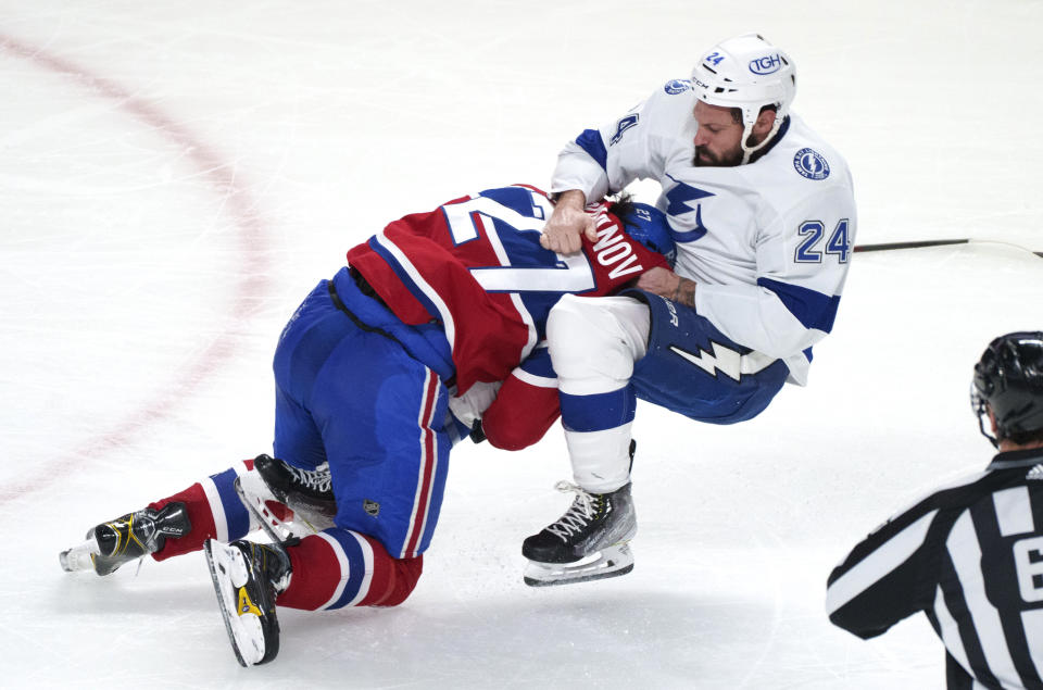 Montreal Canadiens' Alexander Romanov and Tampa Bay Lightning's Zach Bogosian square off during the second period of an NHL hockey game Tuesday, Dec. 7, 2021, in Montreal. (Paul Chiasson/The Canadian Press via AP)