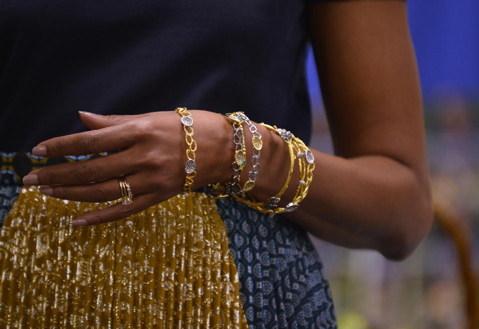 The jewelery worn by US First Lady Michelle Obama is pictured as she speaks during a book signing event of her book 'American Grown: The Story of the White House Kitchen Garden and Gardens Across America,' at Politics & Prose in Washington, DC, on May 7, 2013. Photo credit:  JEWEL SAMAD/AFP/Getty Images