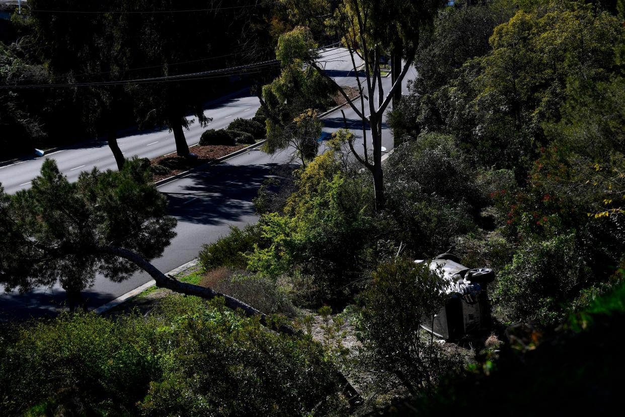 The vehicle driven by golfer Tiger Woods lies on its side in Rancho Palos Verdes, California, on Tuesday.