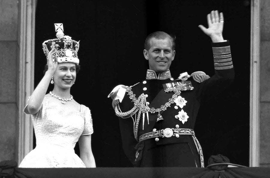 Britain's Queen Elizabeth II and Prince Philip, Duke of Edinburgh wave to supporters from the balcony at Buckingham Palace, following her coronation at Westminster Abbey, on June. 2, 1953.