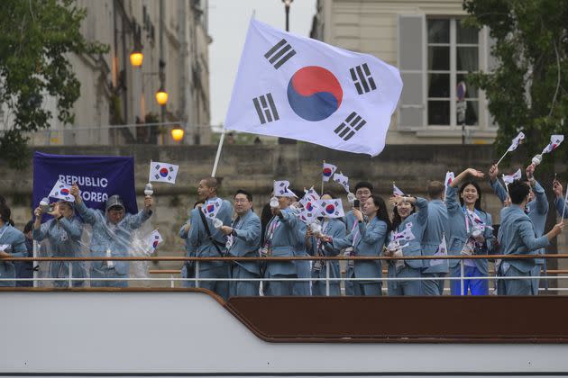 Athletes from South Korea ride a boat along the Seine during the opening ceremony. 