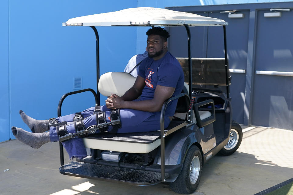 Virginia defensive tackle Olasunkonmi Agunloye watches from the tunnel in the second half of an NCAA college football game against Tennessee, Saturday, Sept. 2, 2023, in Nashville, Tenn. Agunloye injured himself on the sideline during the first half. (AP Photo/George Walker IV)