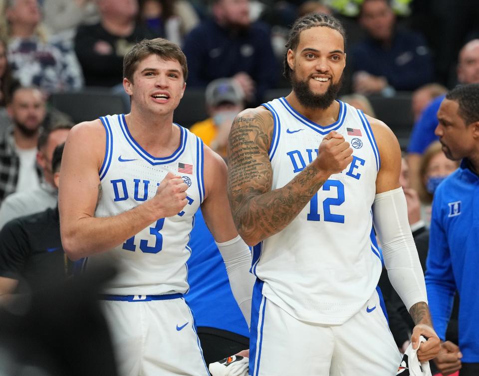 Nov 26, 2021; Las Vegas, Nevada, USA; Duke Blue Devils forwards Joey Baker (13) and Theo John (12) react on the bench during the second half against the Gonzaga Bulldogs at T-Mobile Arena. Mandatory Credit: Stephen R. Sylvanie-USA TODAY Sports