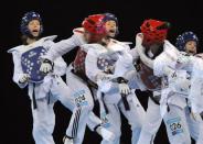 Lucija Zaninovic of Croatia (L, blue helmet) competes against Maieva Coutant of France during the Olympics 2012 Taekwondo test event at the ExCel centre in east London December 3, 2011. Picture taken using an in-camera multiple exposure technique.