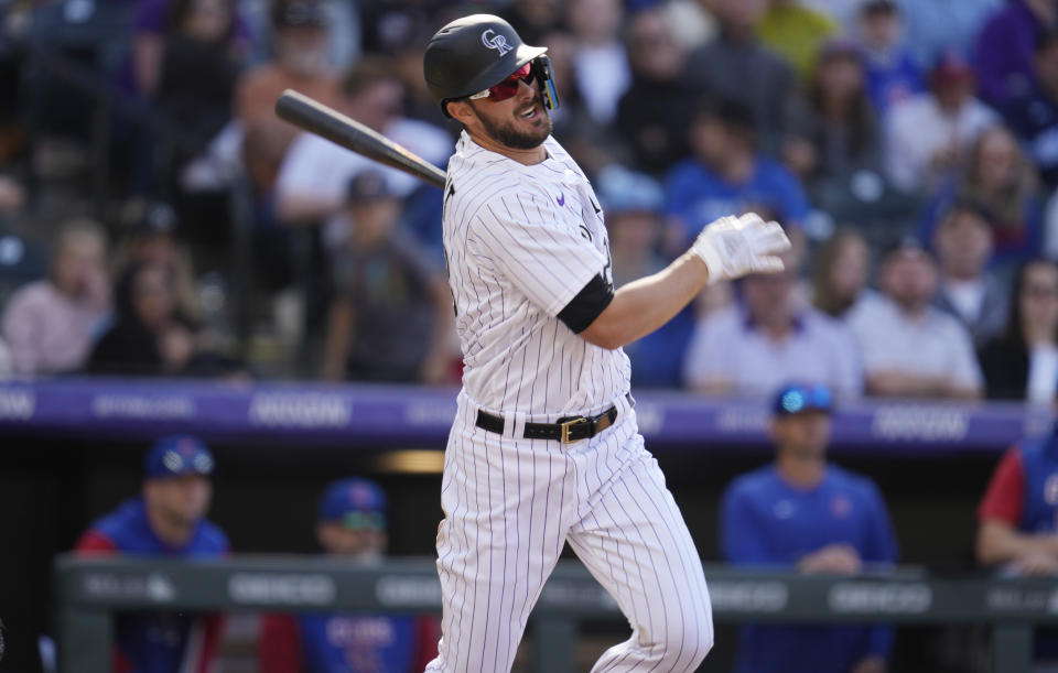 Colorado Rockies' Kris Bryant flies out against Chicago Cubs relief pitcher David Robertson in the ninth inning of a baseball game Sunday, April 17, 2022, in Denver. (AP Photo/David Zalubowski)